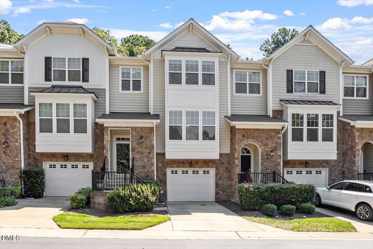 6224 Braidwood Court Raleigh, NC 27612 - Photo 1 of 39 a front view of a house with a yard and garage