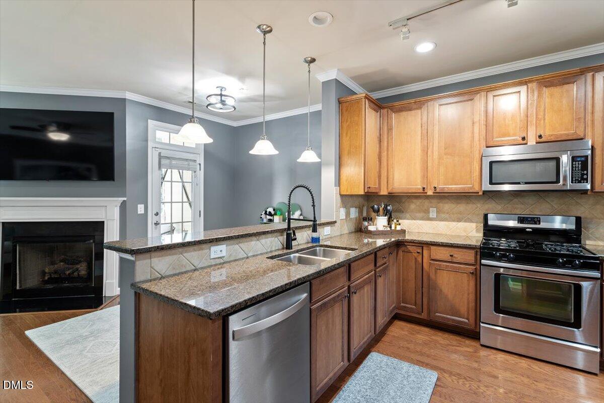 6224 Braidwood Court Raleigh, NC 27612 - Photo 12 of 39 a kitchen with a stove oven and a sink
