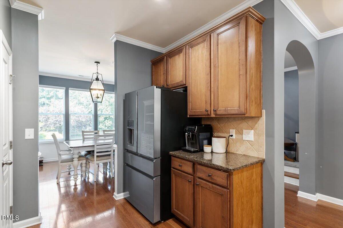 6224 Braidwood Court Raleigh, NC 27612 - Photo 15 of 39 a kitchen with stainless steel appliances granite countertop a refrigerator a stove and a sink with granite countertops