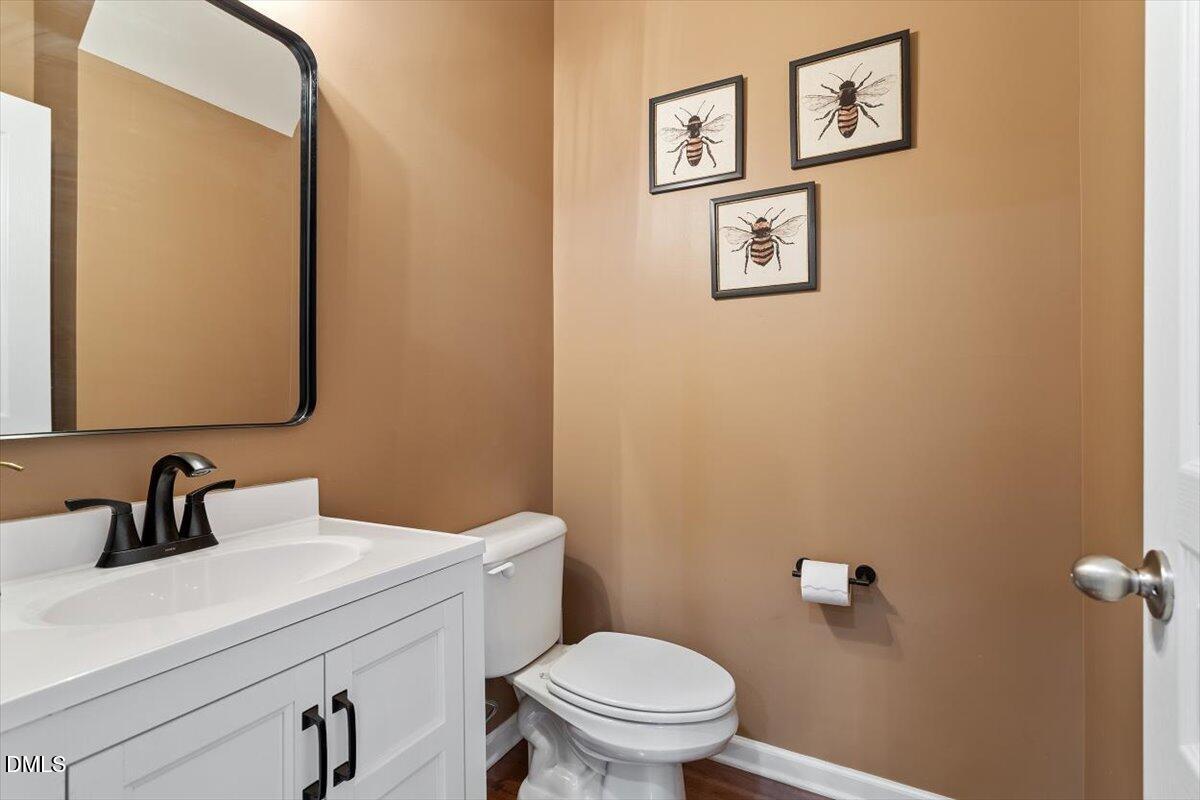 6224 Braidwood Court Raleigh, NC 27612 - Photo 17 of 39 a bathroom with a toilet sink and mirror