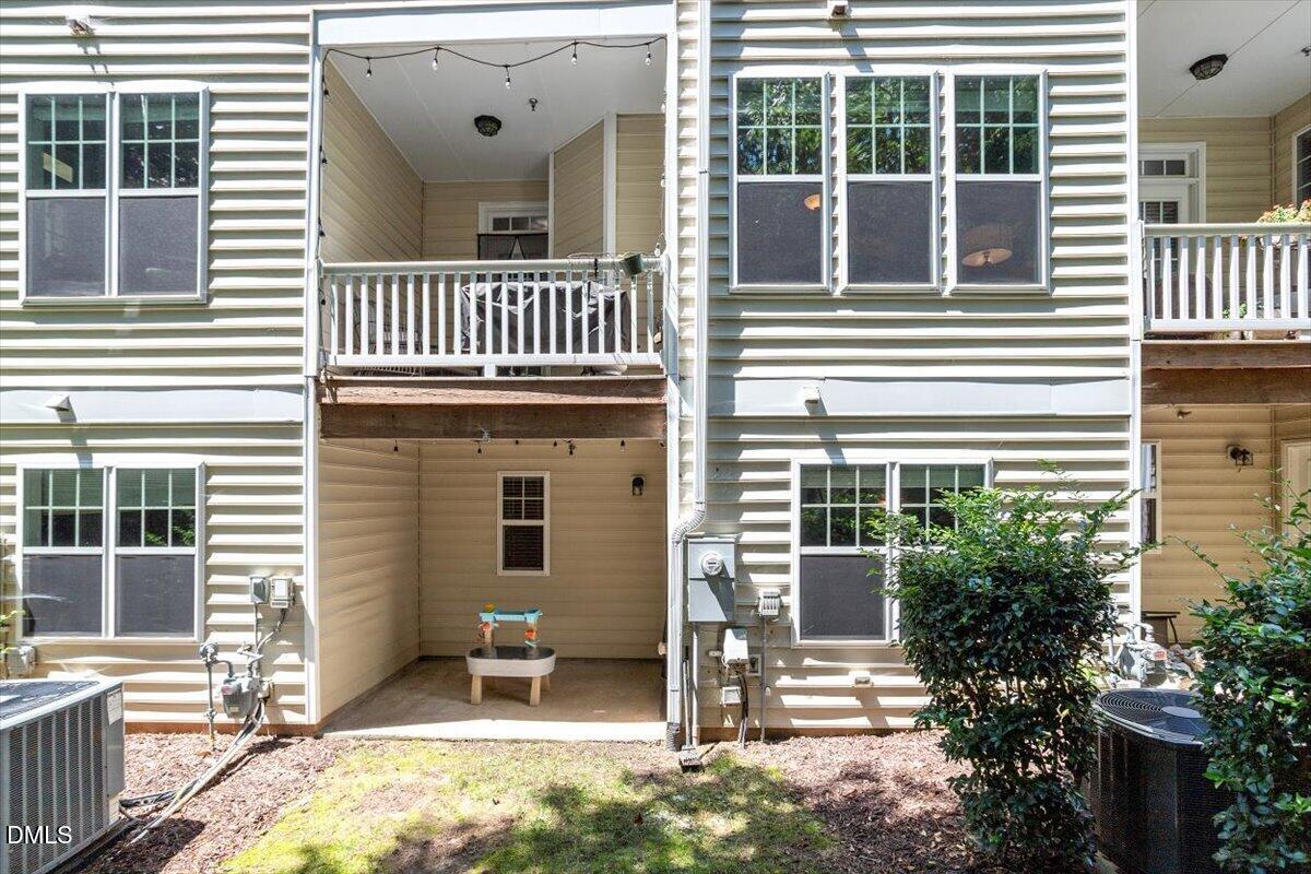 6224 Braidwood Court Raleigh, NC 27612 - Photo 21 of 39 a view of a house with a small deck and a large window