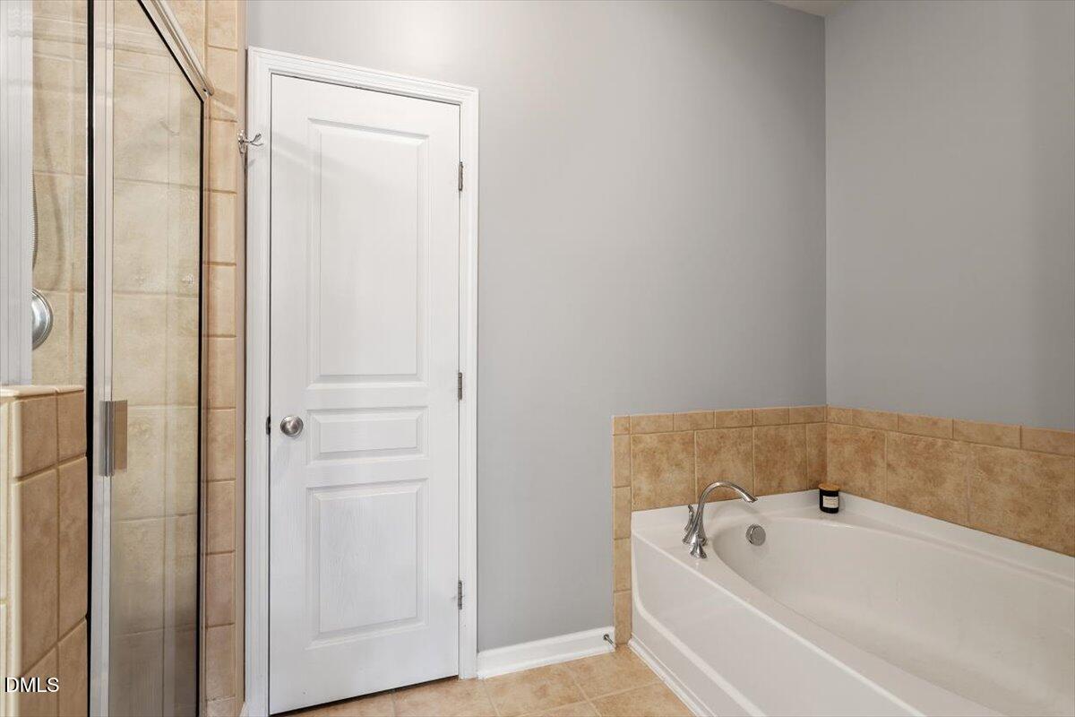6224 Braidwood Court Raleigh, NC 27612 - Photo 28 of 39 a bathroom with a tub shower and sink