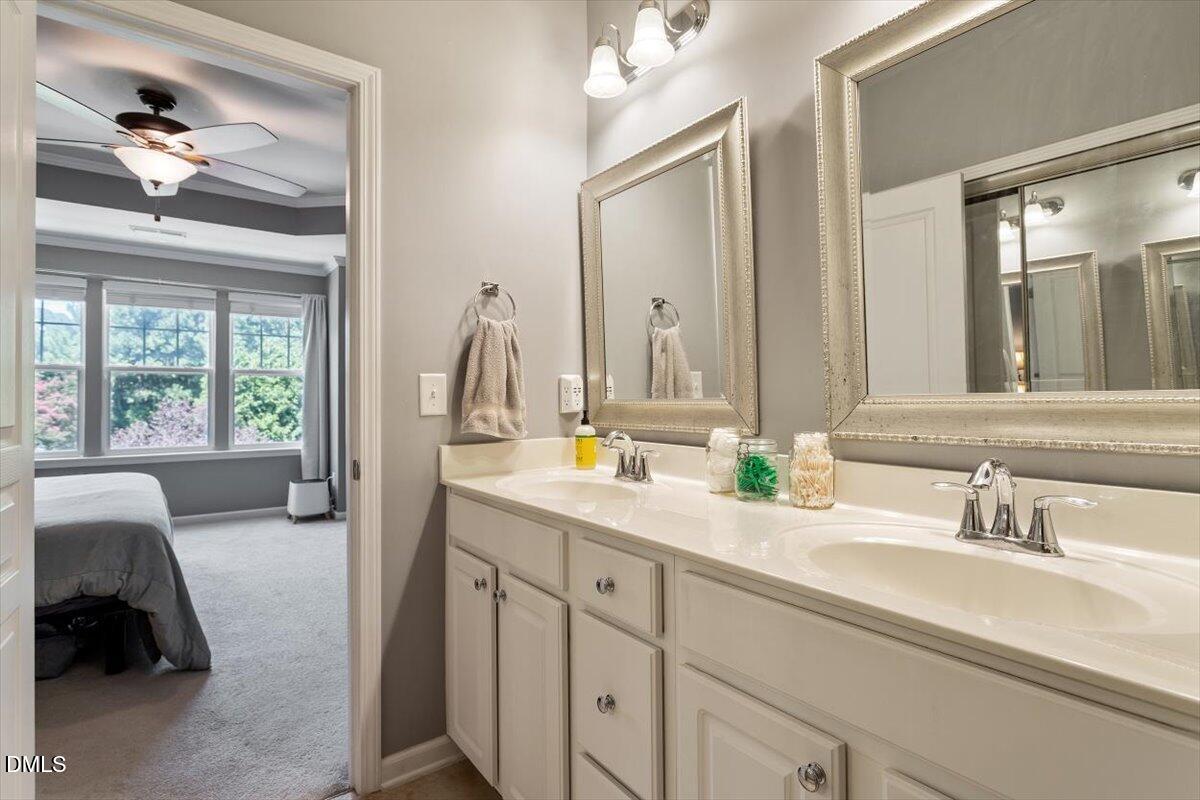 6224 Braidwood Court Raleigh, NC 27612 - Photo 29 of 39 a en suite bathroom with a double vanity sink and a mirror