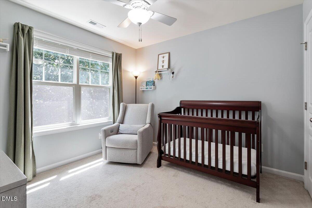 6224 Braidwood Court Raleigh, NC 27612 - Photo 31 of 39 a bedroom with a bed and window