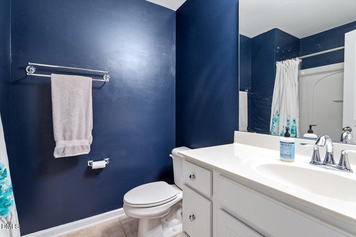 6224 Braidwood Court Raleigh, NC 27612 - Photo 32 of 39 a bathroom with a sink a toilet and mirror