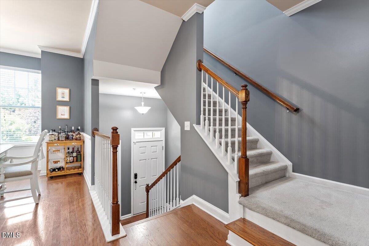 6224 Braidwood Court Raleigh, NC 27612 - Photo 4 of 39 a view of entryway and hall with wooden floor