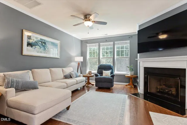 a living room with furniture a flat screen tv and a fireplace