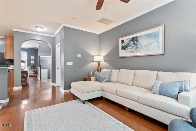 a living room with furniture and a wooden floor