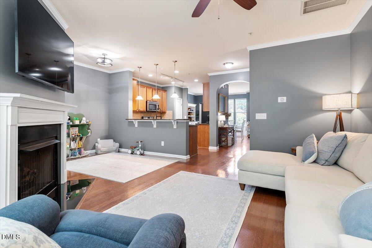6224 Braidwood Court Raleigh, NC 27612 - Photo 9 of 39 a living room with furniture and a flat screen tv