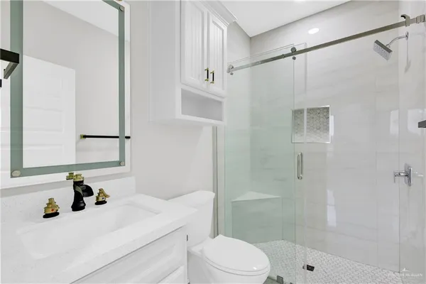 a bathroom with a sink toilet and mirror