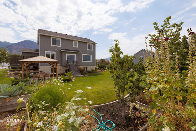 1654 South 730 West Provo, UT 84601 - Photo 31 of 33 Spacious backyard featuring a covered patio, terraced landscaping, and raised garden beds