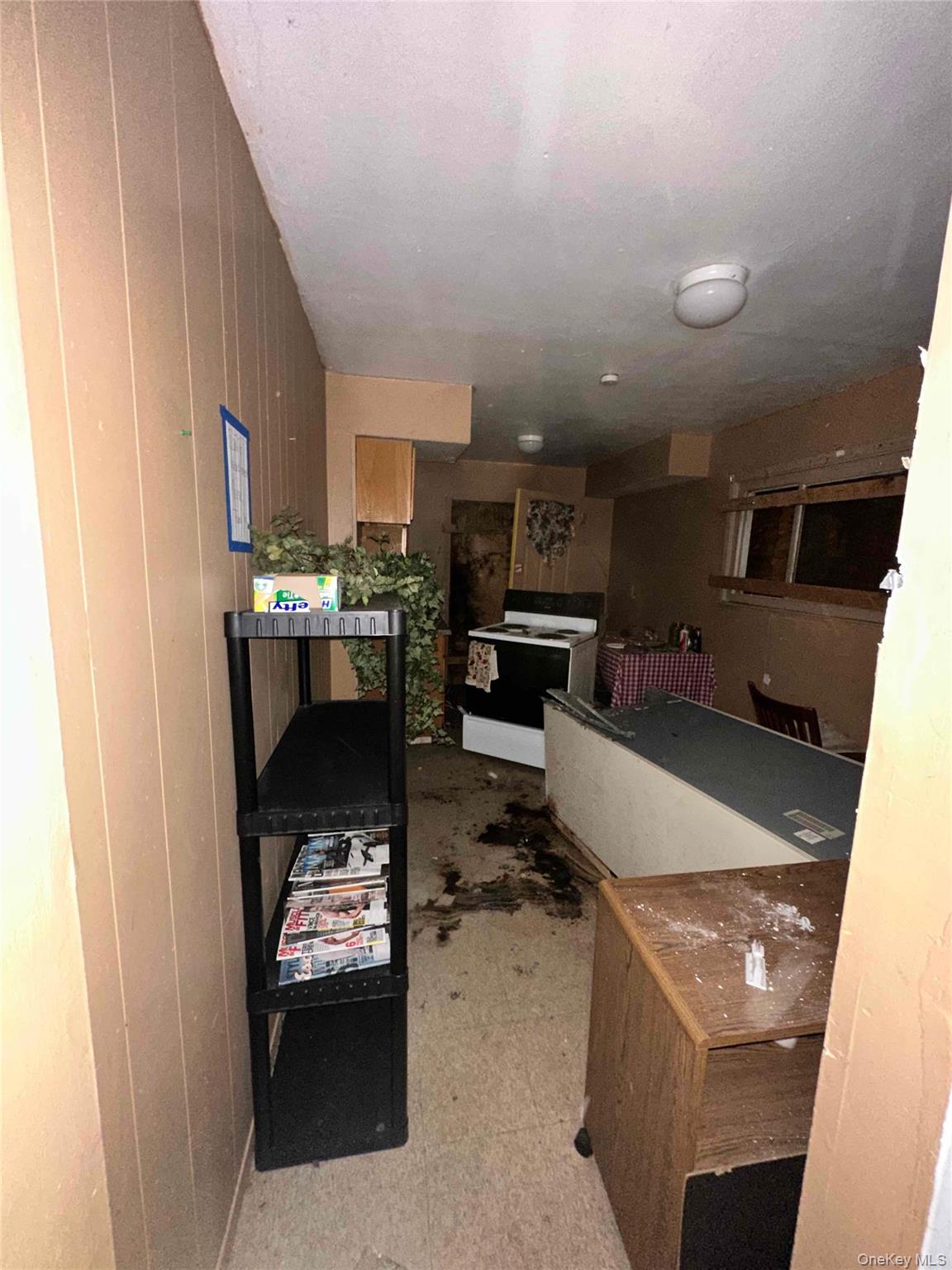 848 Station Road Bellport, NY 11713 - Photo 3 of 4 a living room with stainless steel appliances kitchen island granite countertop a refrigerator and a stove