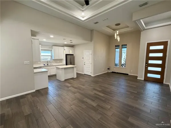 a view of a kitchen with a sink hardwood floor and a large window