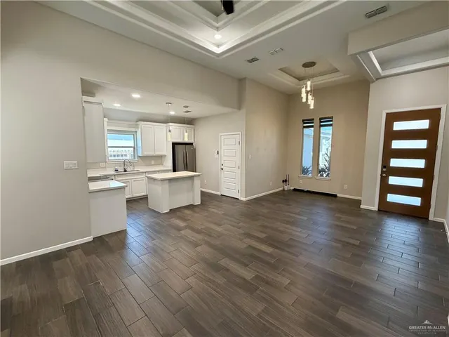 a view of a kitchen with a sink hardwood floor and a large window