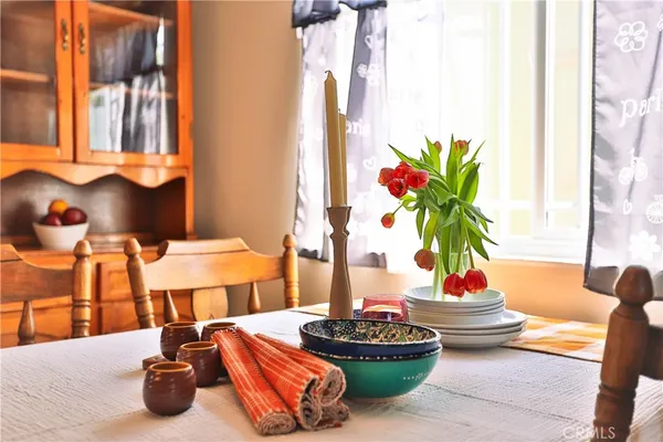 a table with a vase and flowers on it