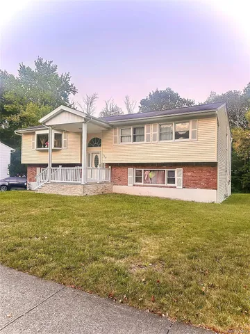 a view of a house with a swimming pool and a yard