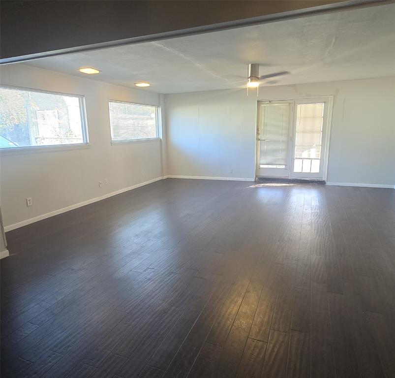2018 Van Cleave Drive Dallas, TX 75216 - Photo 5 of 12 an empty room with wooden floor and windows