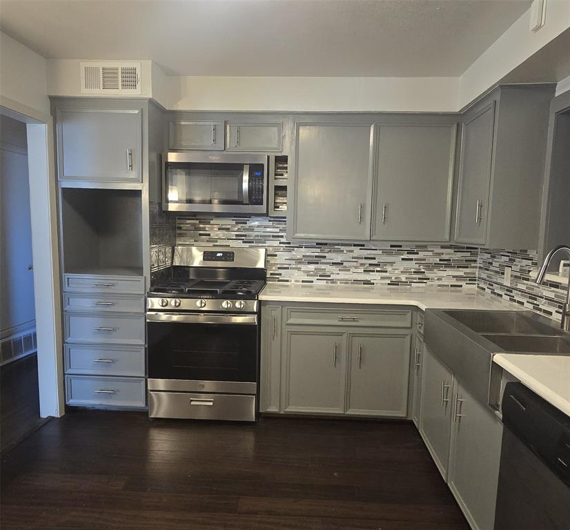 2018 Van Cleave Drive Dallas, TX 75216 - Photo 7 of 12 a kitchen with stainless steel appliances kitchen island granite countertop a stove and a sink