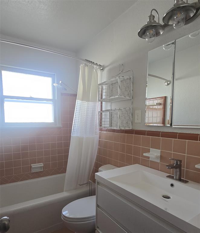 2018 Van Cleave Drive Dallas, TX 75216 - Photo 9 of 12 a bathroom with a sink a toilet and shower