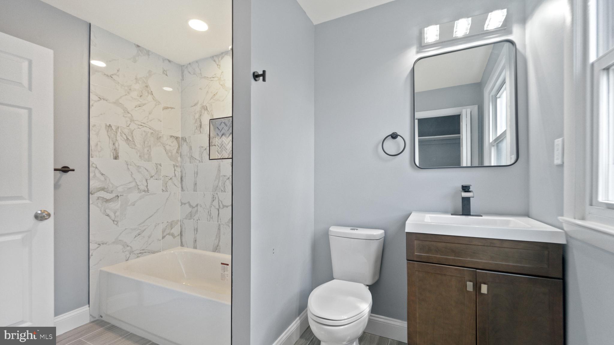 3605 Chapman Road Randallstown, MD 21133 - Photo 50 of 65 a bathroom with a sink a toilet and shower
