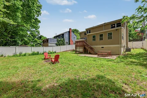 a view of backyard with a garden and deck