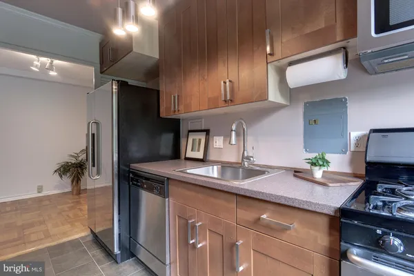 a kitchen with a sink stove and cabinets