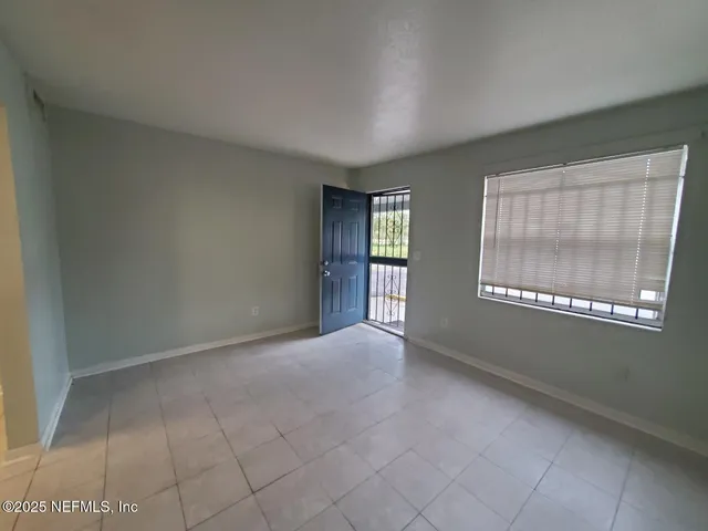 a view of an empty room with a window