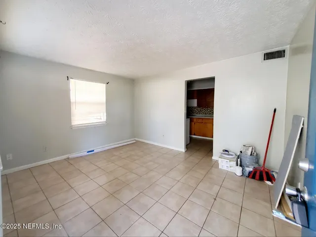 a view of an empty room and a sink