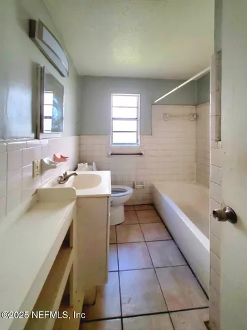 a bathroom with a sink a toilet and bathtub