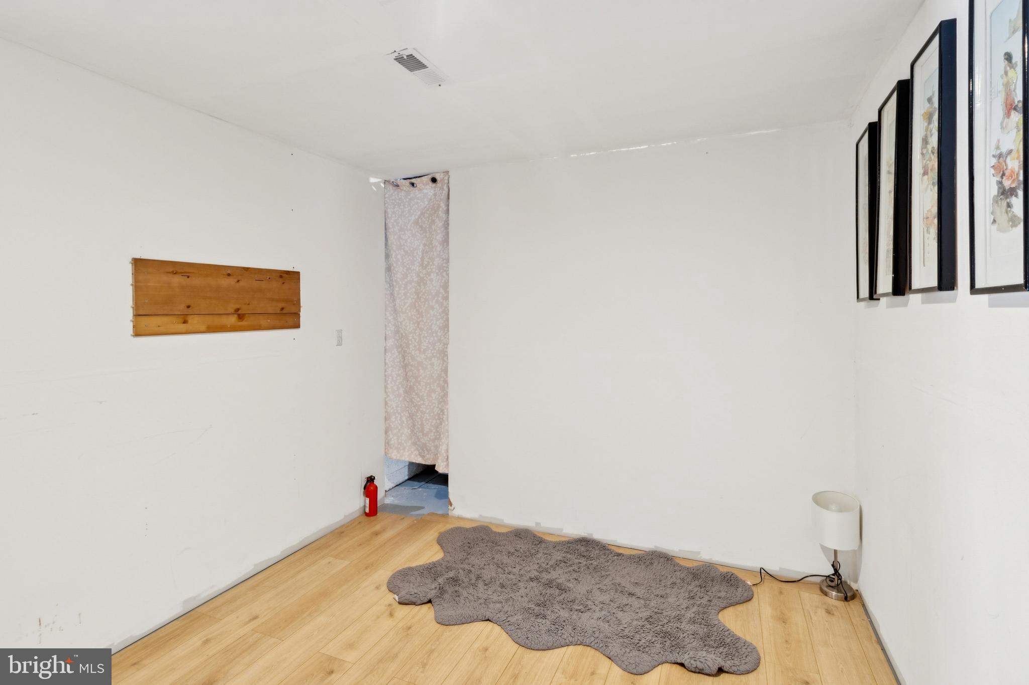 305 Cedar Ridge Drive Oxon Hill, MD 20745 - Photo 18 of 22 a bedroom with a bed and a wall painting