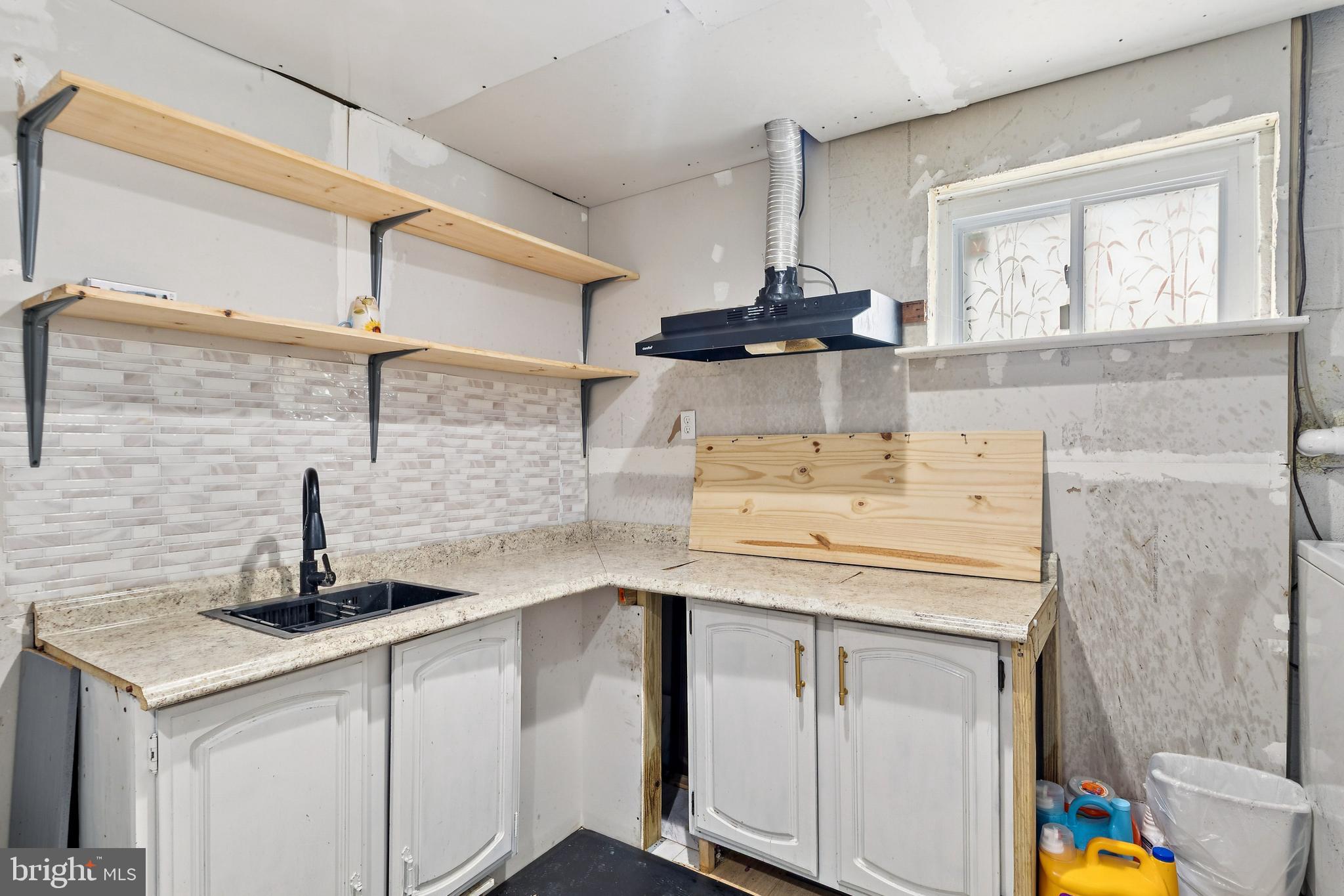 305 Cedar Ridge Drive Oxon Hill, MD 20745 - Photo 20 of 22 a kitchen with a sink cabinets and a window