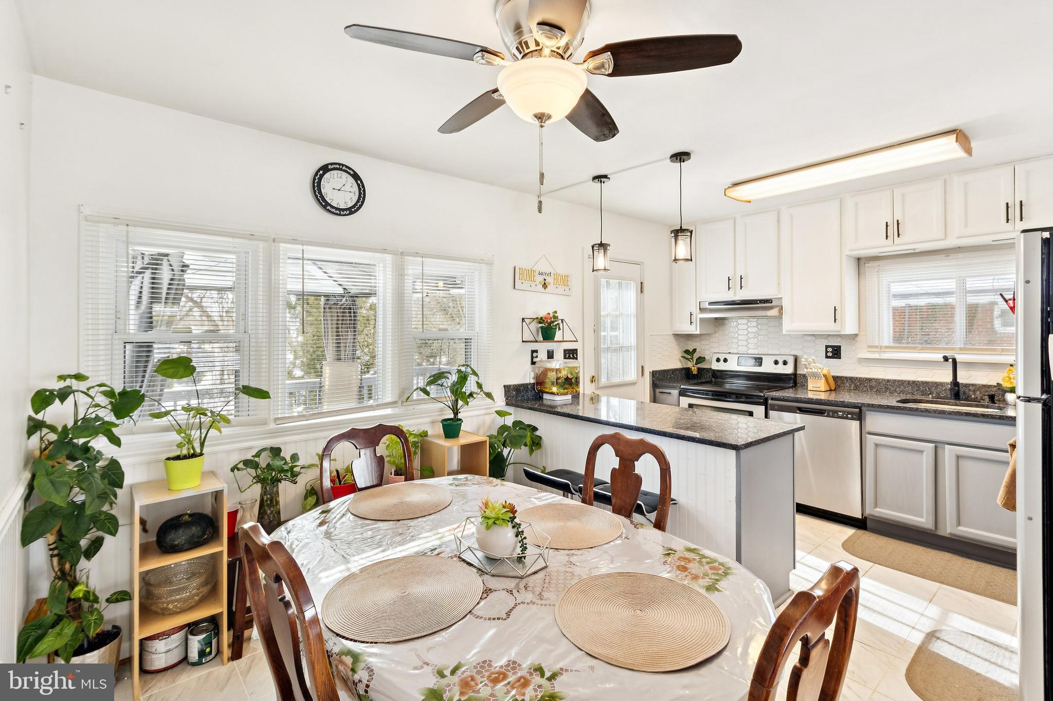 305 Cedar Ridge Drive Oxon Hill, MD 20745 - Photo 2 of 22 a kitchen with granite countertop white cabinets and stainless steel appliances