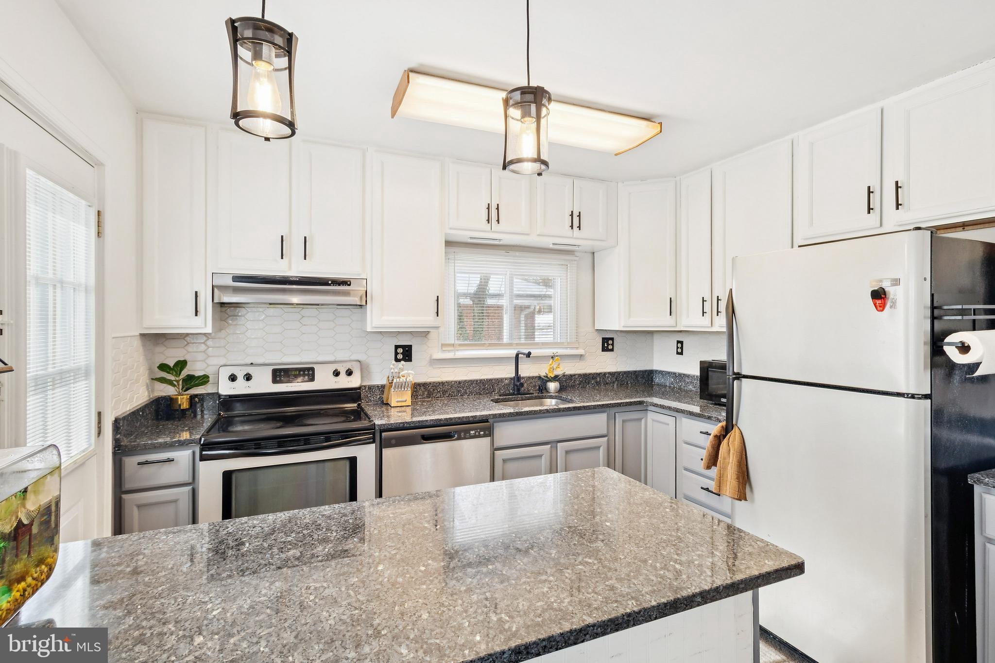 305 Cedar Ridge Drive Oxon Hill, MD 20745 - Photo 3 of 22 a kitchen with kitchen island a stove a refrigerator and a sink