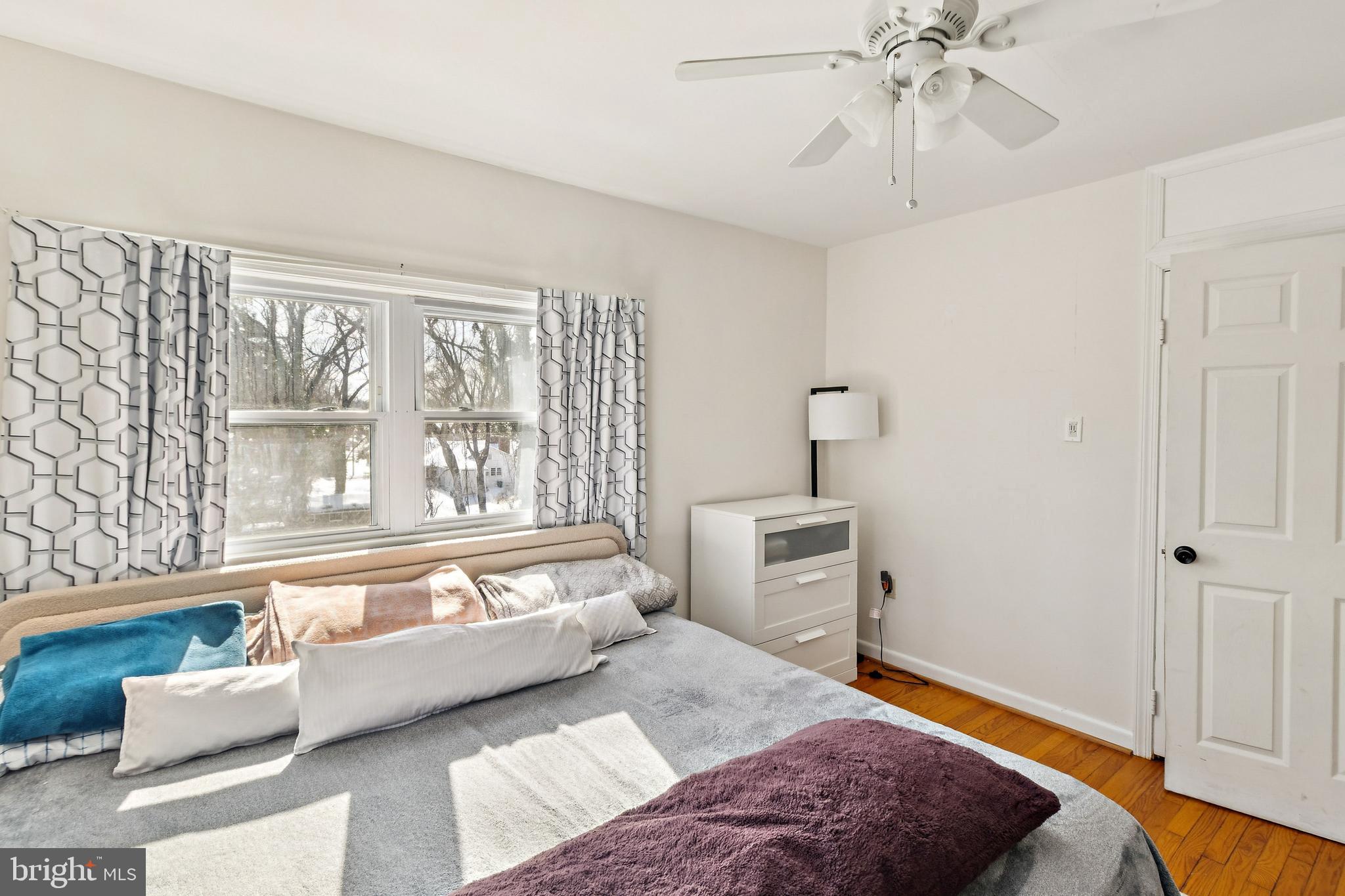 305 Cedar Ridge Drive Oxon Hill, MD 20745 - Photo 7 of 22 a bedroom with a bed and wooden floor