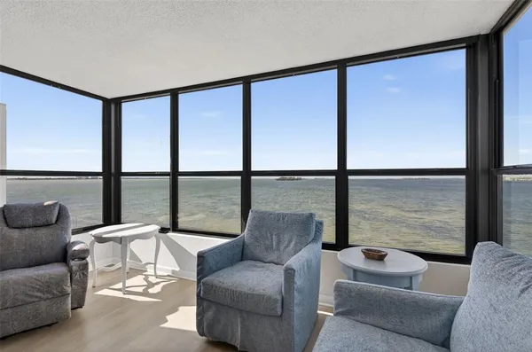 a balcony with furniture and a large window