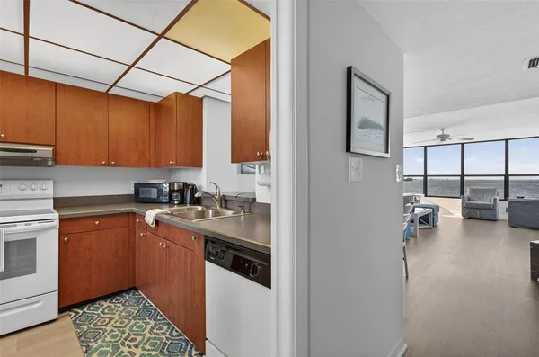 a kitchen with a sink cabinets and window