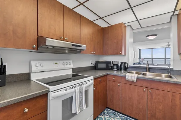 a kitchen with a sink cabinets and appliances