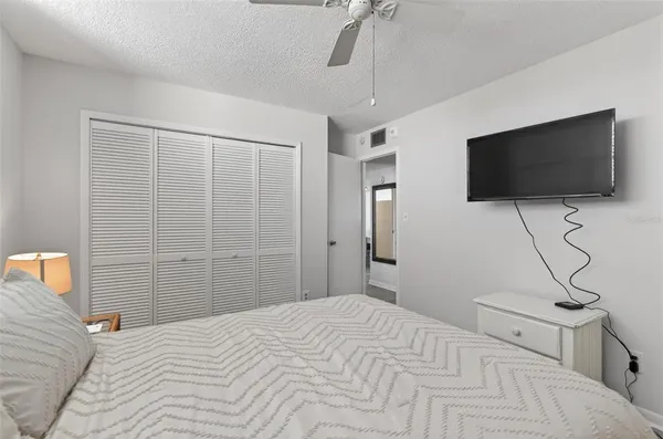 a bedroom with a bed and a flat screen tv