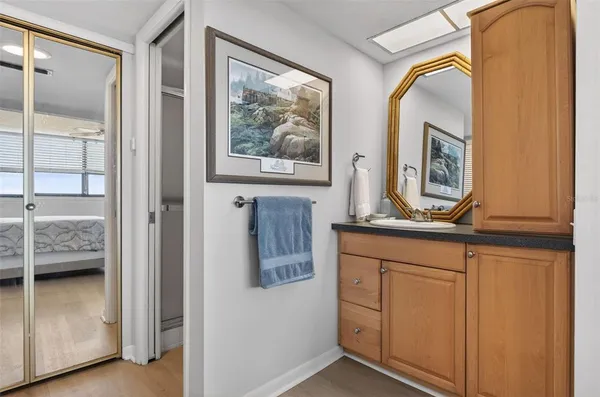 a bathroom with a tub and a view of living room