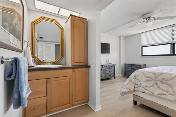a bedroom with a bed a mirror and a dresser