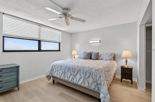 a bedroom with a bed and a ceiling fan