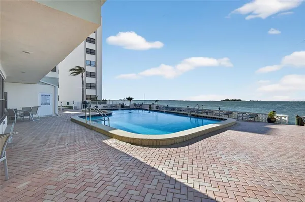 a view of a swimming pool with seating