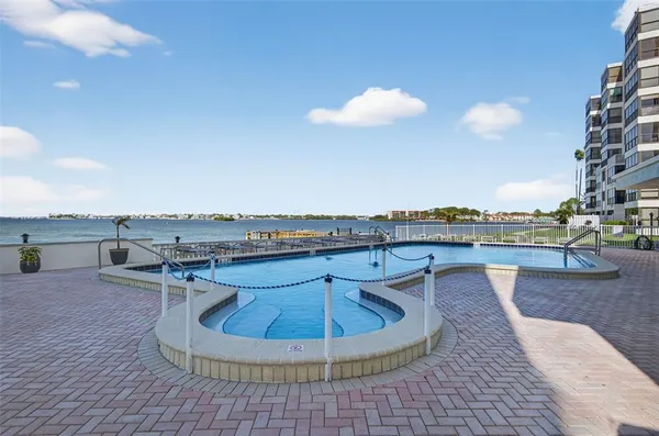 swimming pool view with a seating space