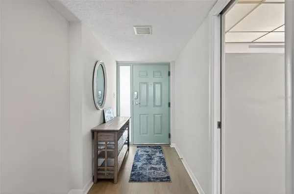 a view of entryway with wooden floor