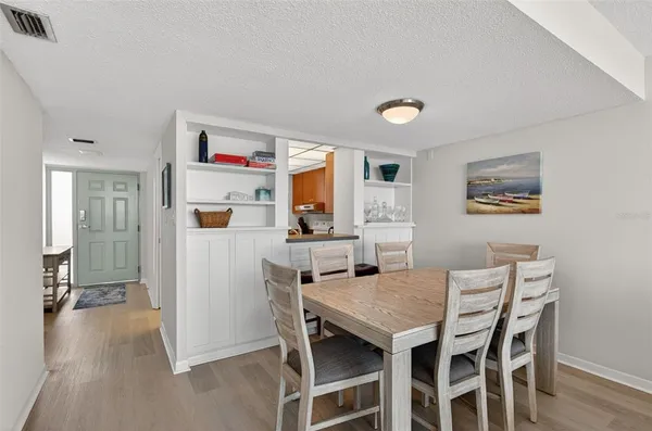 a view of a dining room with furniture and a kitchen