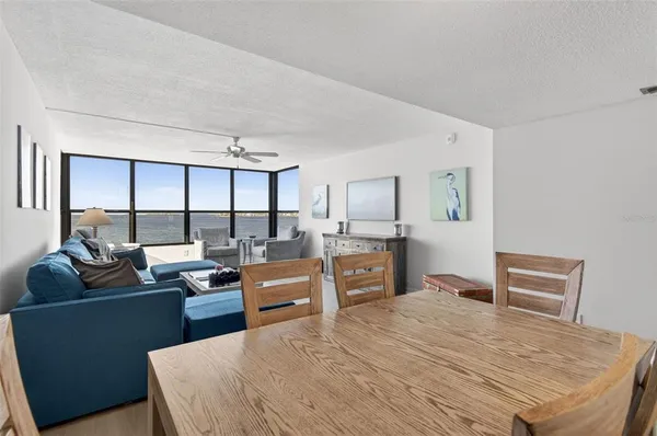 a bedroom with furniture window and flat screen tv