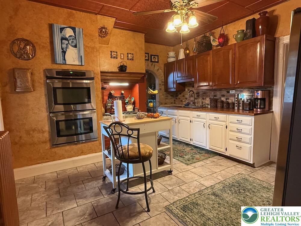 6423 Front Street Bangor, PA 18013 - Photo 12 of 60 a kitchen with stainless steel appliances a stove a sink cabinets and a dining table