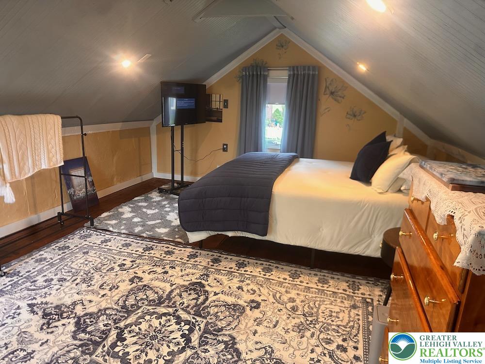 6423 Front Street Bangor, PA 18013 - Photo 56 of 60 a bedroom with a bed and a dresser with rug