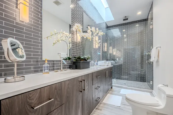 a spacious bedroom with a bed and a chandelier