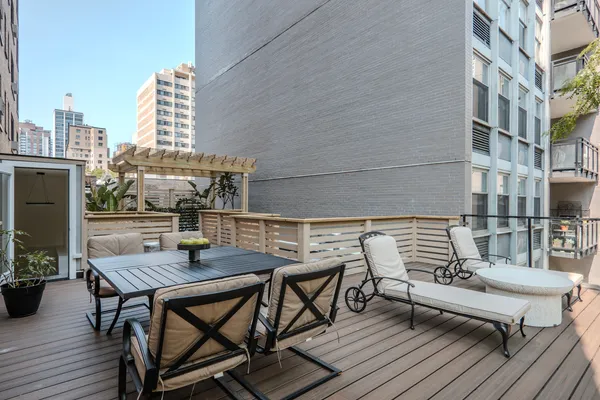 a balcony with table and chairs